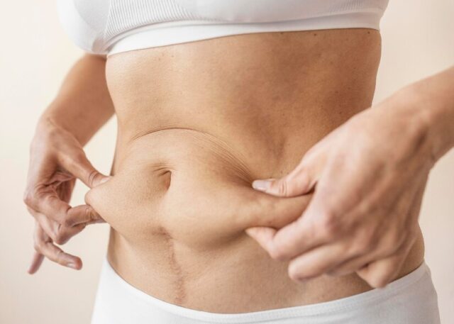 close-up-hands-holding-belly_23-2148889319