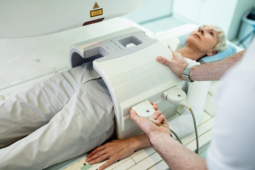 unrecognizable-radiologist-preparing-female-patient-abdomen-mri-scan-procedure-hospital_637285-423